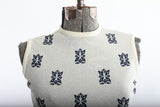 Vintage 1960s Cream Bouclé Knit Navy Tiki Print Sleeveless Shirt  |  Large  |  by Talbott Travler