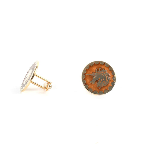 vintage 1960s unicorn cufflinks in gold toned metal and amber with left cufflink shown turned to side and right cufflink shown straight on