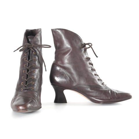 vintage 1990s does Edwardian style brown leather curved heel lace up boots shown with left boot pointed forward and right boot turned to show side on white background