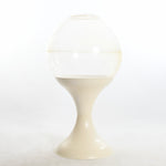 vintage 1970s full size clear and cream globe shaped terrarium sitting on cream base shown on white background