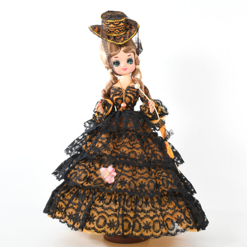 vintage late 60s 1970s big eye blond boudior doll with black lace overlay orange large hooped skirt dress holding parasol with hat on white background