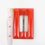 vintage 30s red bakelite belt buckle showing tape measure 3.25 inches long