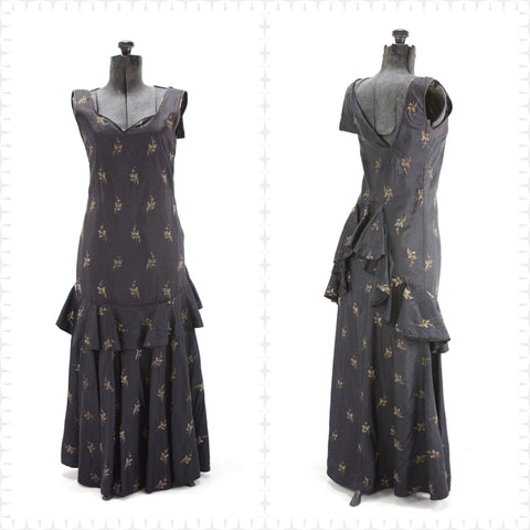 1920s navy blue taffeta evening gown embroidered with gold metallic tulips, sweetheart neckline, assymetrical back with ruffled bustle that swoops down across to circle front