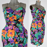 vintage 1980s tropical print strapless sun dress with bold orange purple flowers on black background and green foliage on black background, sweetheart neckline, boned bodice and pockets 