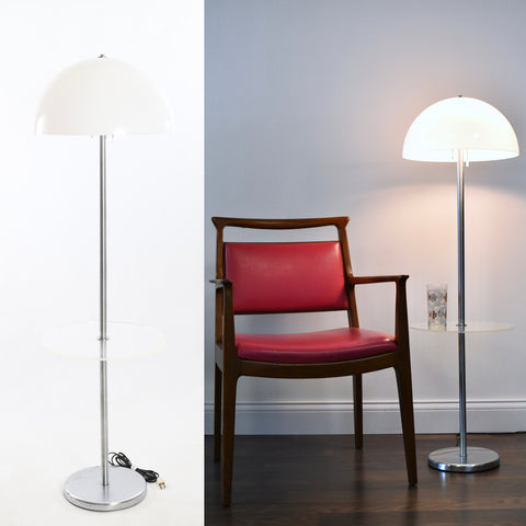 vintage 1960s early 70s white acrylic domed chrome floor lamp with built on clear lucite tabletop shown on white background left image with right area of image showing lamp lit with drinking glass on table top right image next to mcm pink wood chair